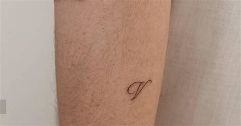 Minimalistic Style Letter V Tattoo Located On The