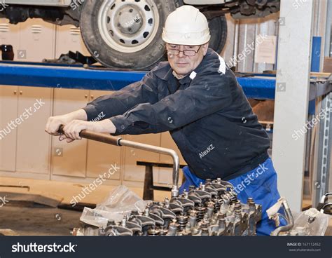 Mechanic Working On An Engine. Stock Photo 167112452 : Shutterstock