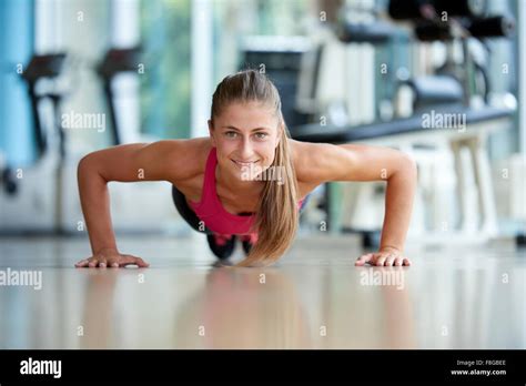 Gorgeous Blonde Woman Warming Up And Doing Some Push Ups A The Gym