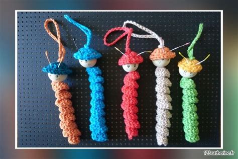 Three Crocheted Items Are Hanging On A String With Two Eyes And One Nose