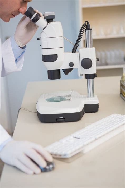 Examining A Sample Under A Microscope Stock Photo Image Of Equipment