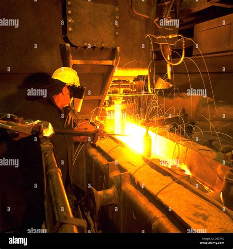 Steelworker Enabling Flow Of Molten Steel Into Tundish Above Continuous