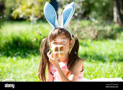 Girl Holding Easter Hot Cross Bun Stock Photo Alamy