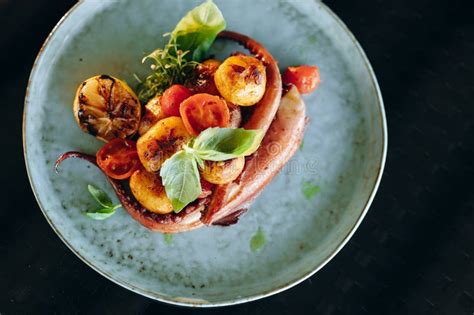 Grilled Octopus Tentacles With Cherry Tomatoes And Baked Baby Potatoes