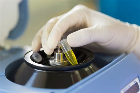 Premium Photo Close Up Of Scientist Putting Test Tube Into Centrifuge