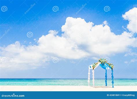 Wedding Arch Decorated With Flowers On Tropical Beach Outd Stock Image