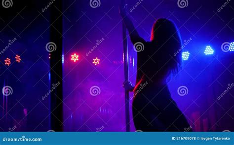 Woman With Long Flowing Hair Spinning Around A Pole In A Dark Room Stock Footage Video Of