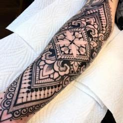 A Black And White Tattoo Design On The Arm