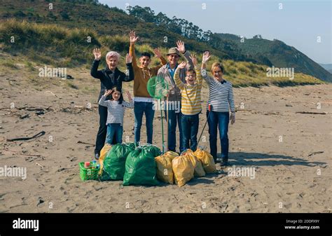 Volunteers posing after cleaning the beach Stock Photo - Alamy