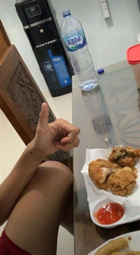 A Woman Sitting At A Table With Some Food In Front Of Her