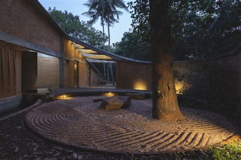 Twisting Rammed Earth Home Wraps Around A Grand Jackfruit Tree