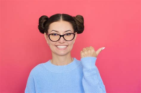 Premium Photo Young Pretty Happy Woman In Glasses Smiles And Points