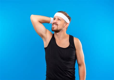 Free Photo Confused Young Handsome Sporty Man Wearing Headband And