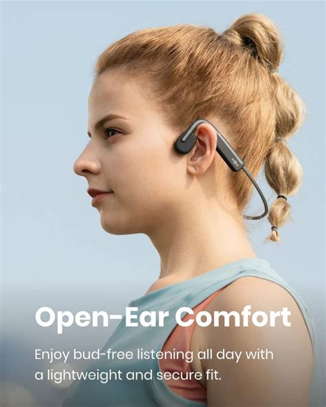 A Woman With Ear Buds On Her Ears And The Words Open Ear Comfort Below It