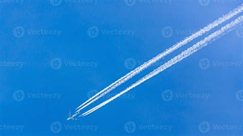 Four Engined Airplane During Flight In High Altitude With Condensation