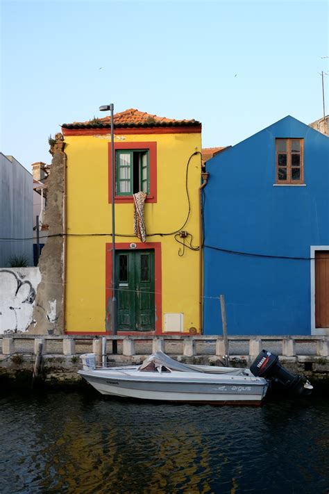 Blue And Yellow Concrete Building Beside Body Of Water During Daytime Photo Free Aveiro Image