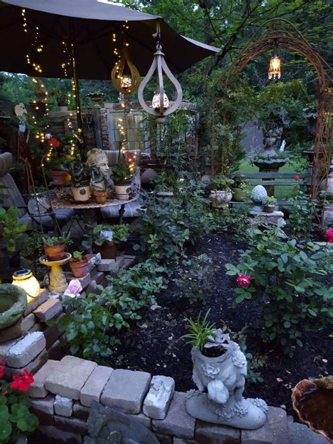 An Outdoor Garden With Lots Of Plants And Lights