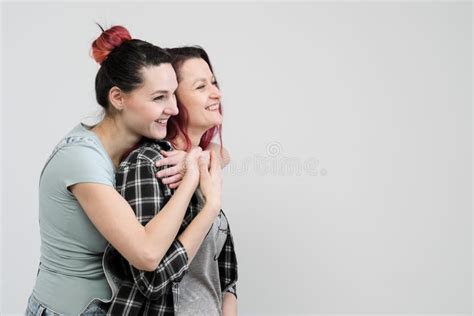 Two Girls Hug On A White Background Homosexual Lesbian Couple Casual