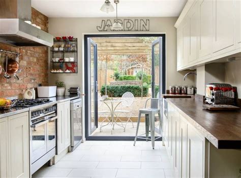 A Kitchen With An Open Door Leading To The Outside