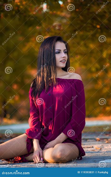 Beautiful Woman Posing Sitting Ground In Autumn Park Stock Image