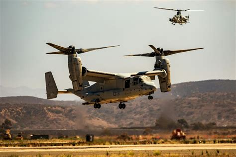 Gray Military Aircraft Flying over Green Grass Field · Free Stock Photo