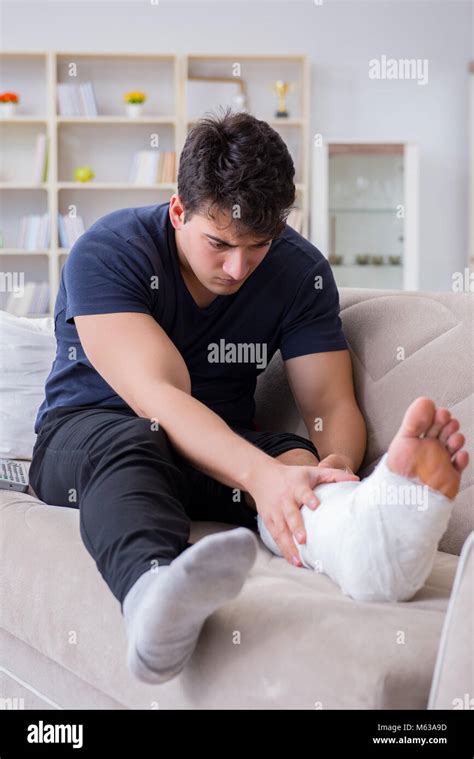 Man With Broken Leg Recovering At Home Stock Photo Alamy