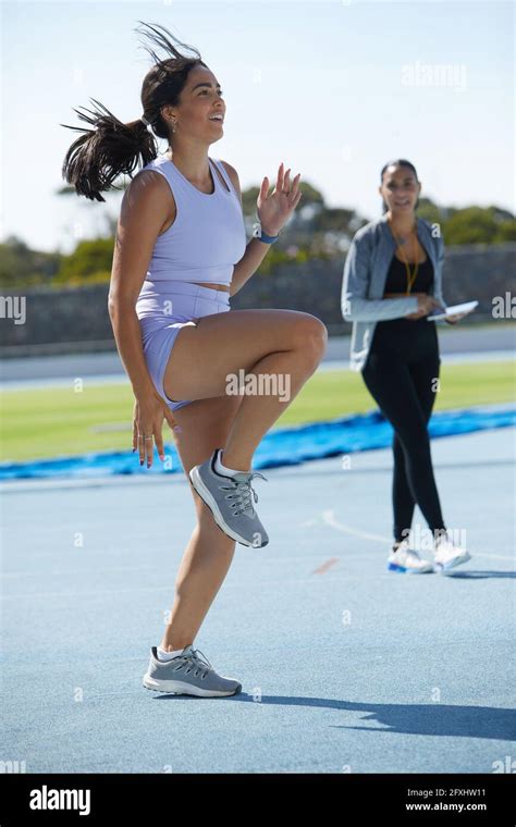 Female Track And Field Athlete Warming Up On Track Stock Photo Alamy