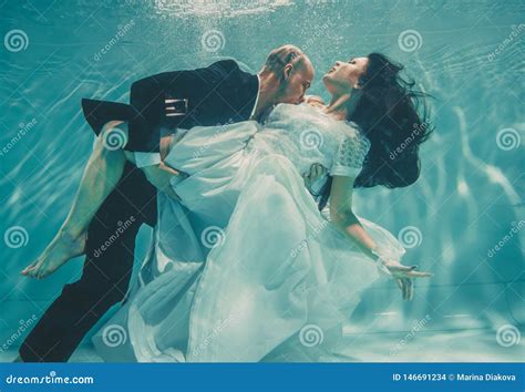 Beautiful Romantic Couple Of Bride And Groom After Wedding Swimming