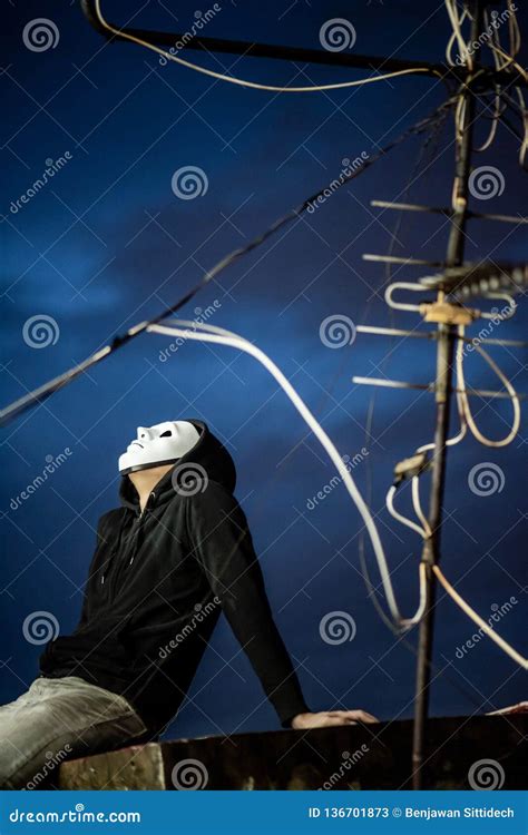 Mystery Man In White Mask Sitting On Rooftop Stock Image Image Of