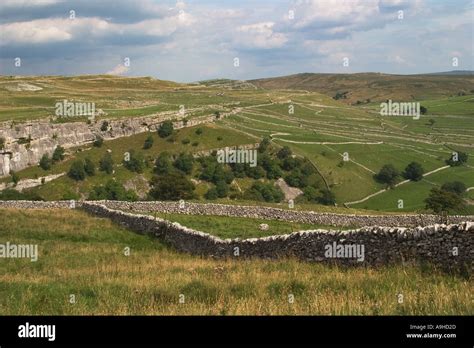 Dry Stone Walls Around Fields And Sheep Pen Across Moorlands To Rugged