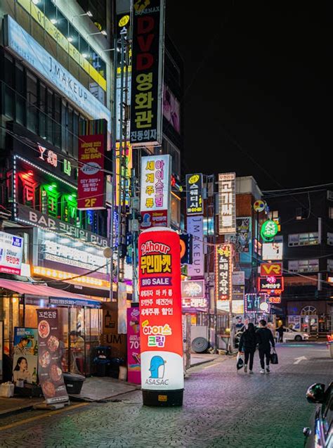 Couple Walking on Street During Night Time · Free Stock Photo