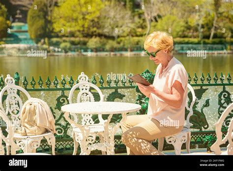 Mature Attractive Woman Traveler Sitting Alone On The Terrace Of Coffee Shop Stock Photo Alamy