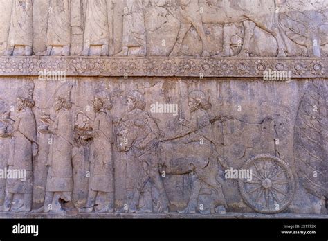 Detailed Stone Engravings Depicting People And Animals In Motion A