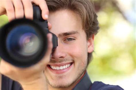 Front View Of A Photographer Photographing With A Dslr Camera Stock