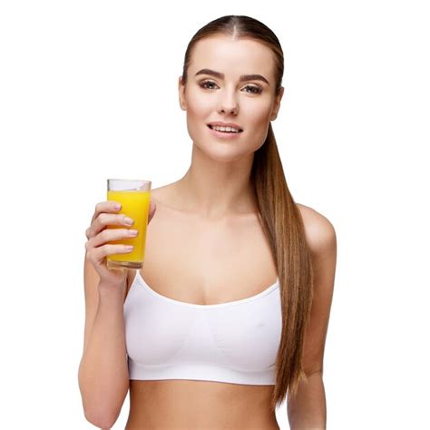 Premium Photo Attractive Smiling Woman Holding Glass Of Orange Juice