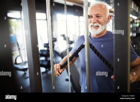 Happy Fit Mature Man In Gym Working Out To Stay Healthy Stock Photo Alamy