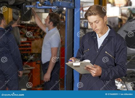 Apprentice Mechanic Working In Auto Repair Shop Stock Image Image Of