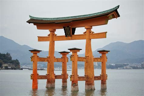 Brown Concrete Building Near Body Of Water During Daytime Photo Free Japan Image On Unsplash