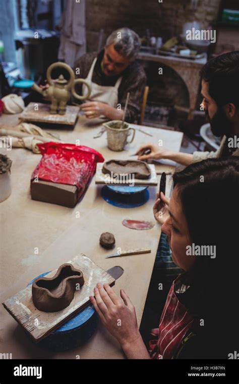 Concentrated Potters Working At Table Stock Photo Alamy