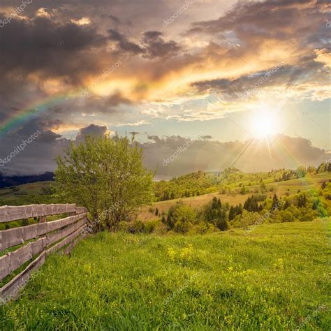 Fence On Hillside Meadow In Mountain At Sunset Stock Photo By Pellinni