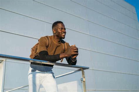 Man Leaning On Railing While Looking Away Stock Photo