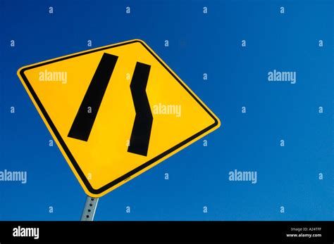 Freeway sign showing merge left as lane ends Stock Photo - Alamy