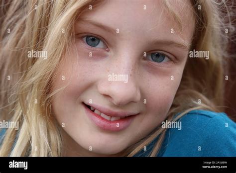 Closeup Of A Smiling Beautiful Innocent Blonde Teenage Girl Stock Photo