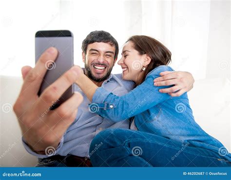 Nice Attractive Young Couple Sitting Together In Sofa Couch Taking