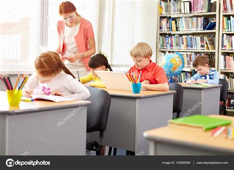 School Kids Busy With Schoolwork Stock Photo By ©pressmaster 130590094