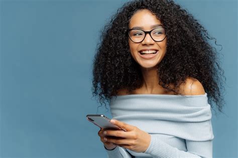 Premium Photo Delighted Dark Skinned Woman With Crisp Hair Looks Away