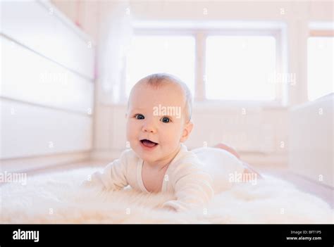 Baby Lying On Rug Stock Photo Alamy