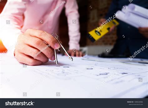 Engineers Pointing Building On Blueprint Using Stock Photo 1380630986