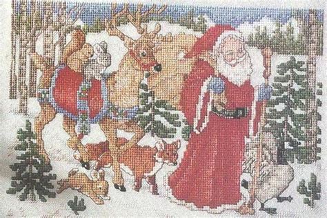 A Cross Stitch Christmas Scene With Santa And Reindeers