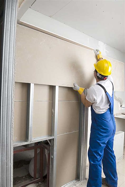 Worker Hanging Drywall | Poulin Lumber